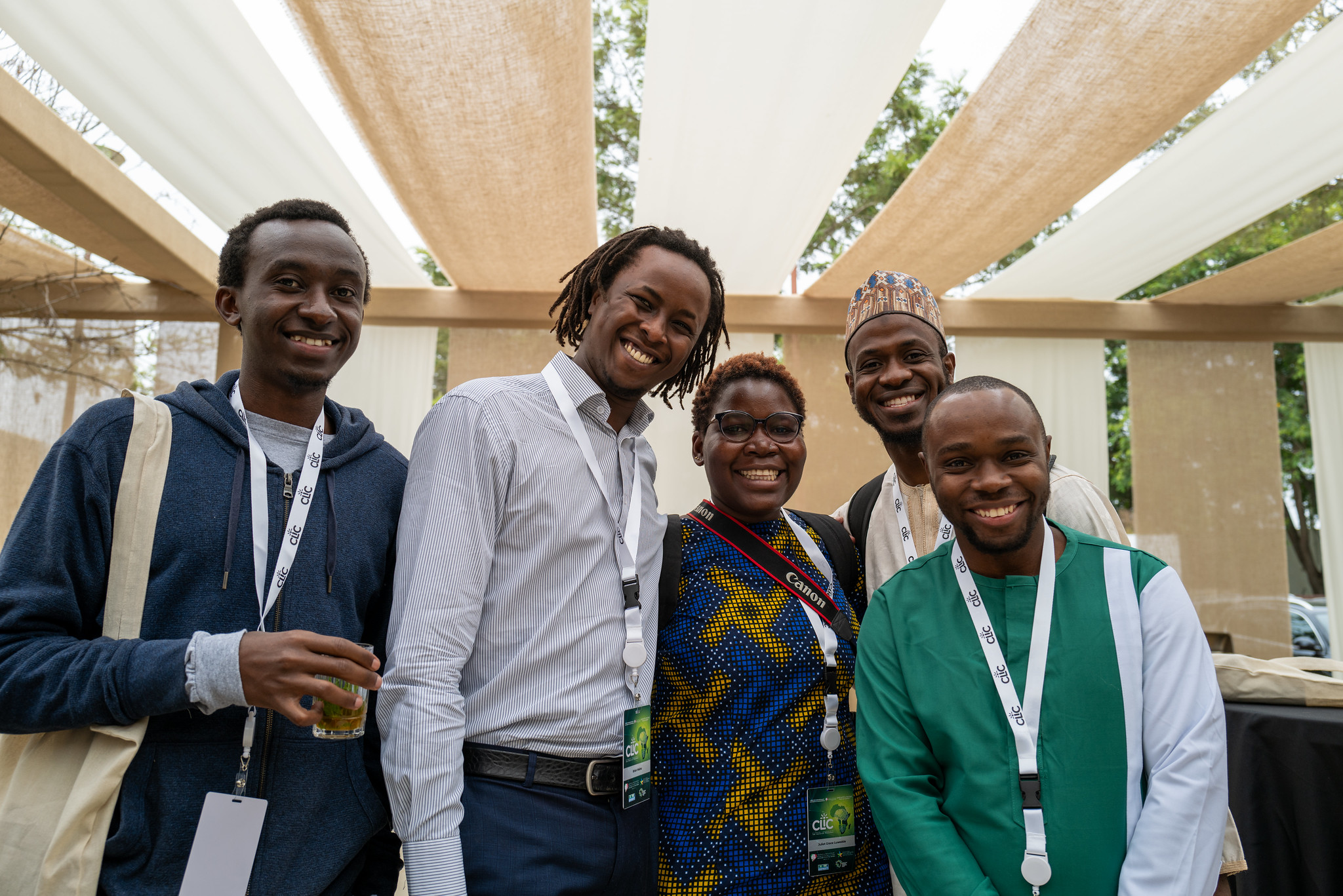 Five young Africans pose for a group photo under a canopy at the Climate Leadership and Innovation Conference.